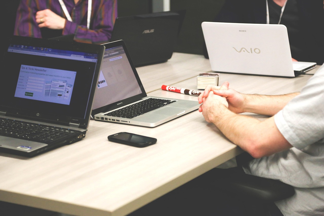 Team working on laptops around a meeting table